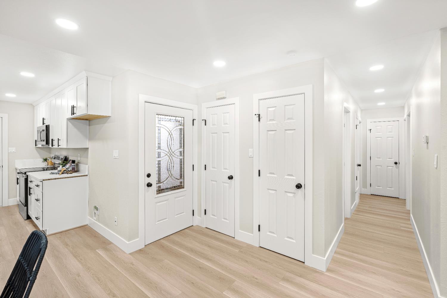 5610 Millburn Street Carmichael, CA 95608 - Photo 19 of 44 a view of a kitchen with white cabinets and wooden floor