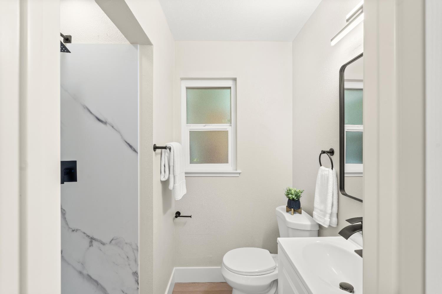 5610 Millburn Street Carmichael, CA 95608 - Photo 27 of 44 a white toilet sitting next to a bathroom sink