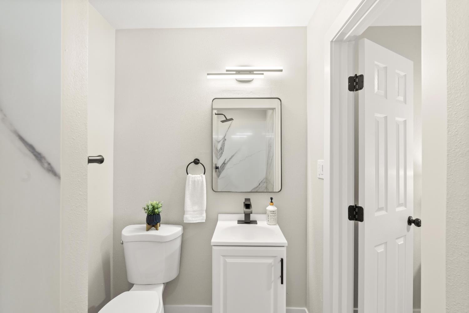 5610 Millburn Street Carmichael, CA 95608 - Photo 28 of 44 a bathroom with a toilet sink and mirror