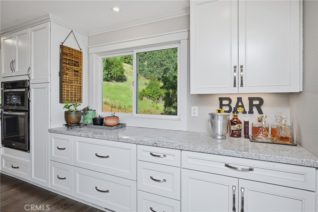 17432 Greenridge Road Hidden Valley Lake, CA 95467 - Photo 27 of 72 a kitchen with granite countertop white cabinets and a window