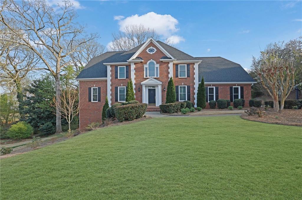 a front view of a house with a garden