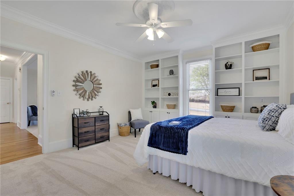 2430 Stonevalley Lane Cumming, GA 30041 - Photo 14 of 45 a bedroom with a large bed and a chandelier