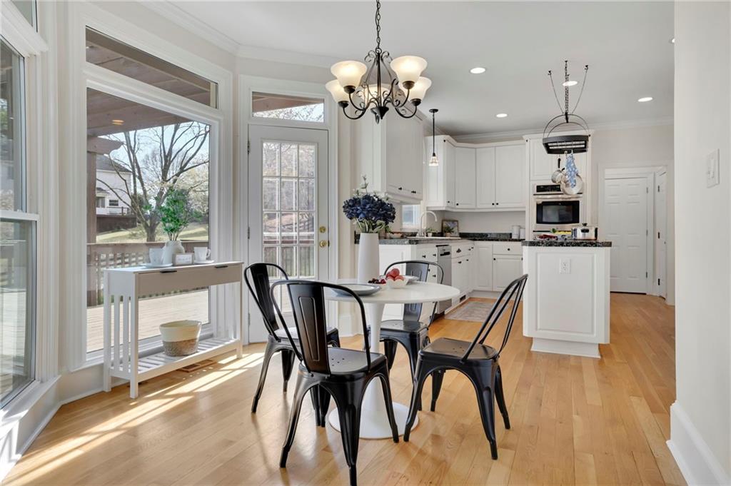 2430 Stonevalley Lane Cumming, GA 30041 - Photo 21 of 45 a dining room filled chandelier and wooden floor