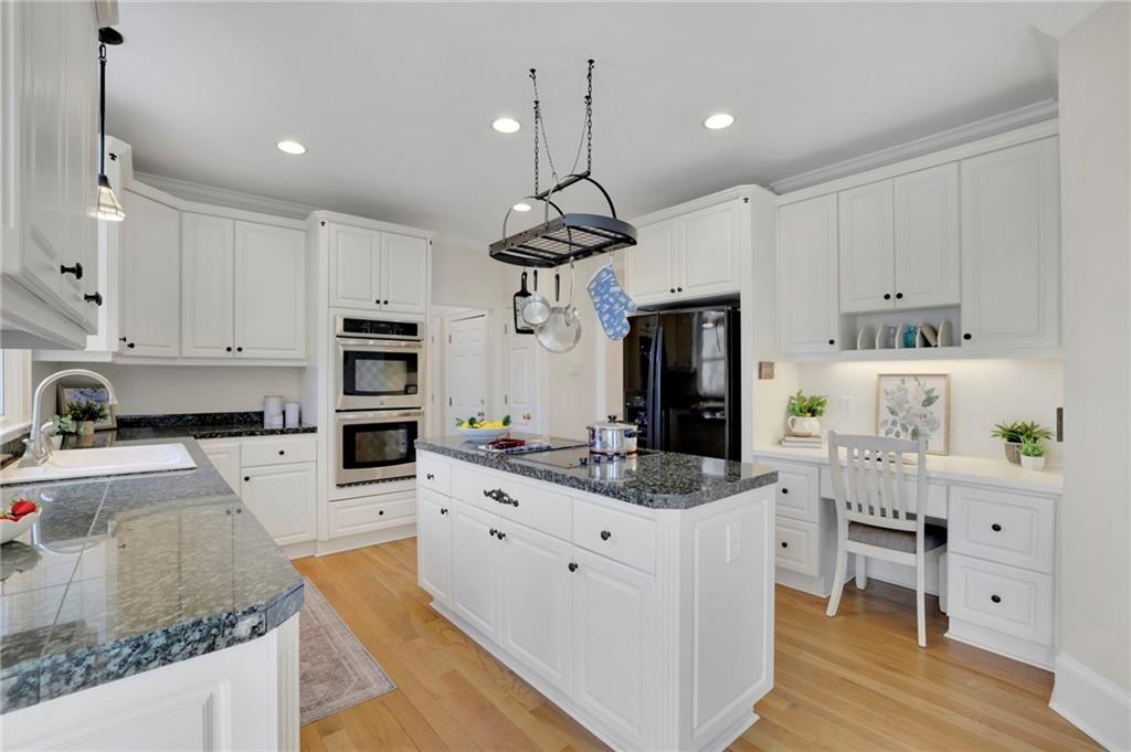 2430 Stonevalley Lane Cumming, GA 30041 - Photo 22 of 45 a kitchen with granite countertop a sink a counter space appliances and cabinets