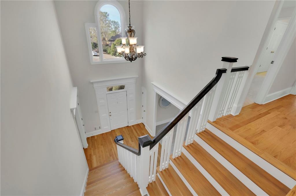 2430 Stonevalley Lane Cumming, GA 30041 - Photo 27 of 45 a view of staircase with railing and wooden floor
