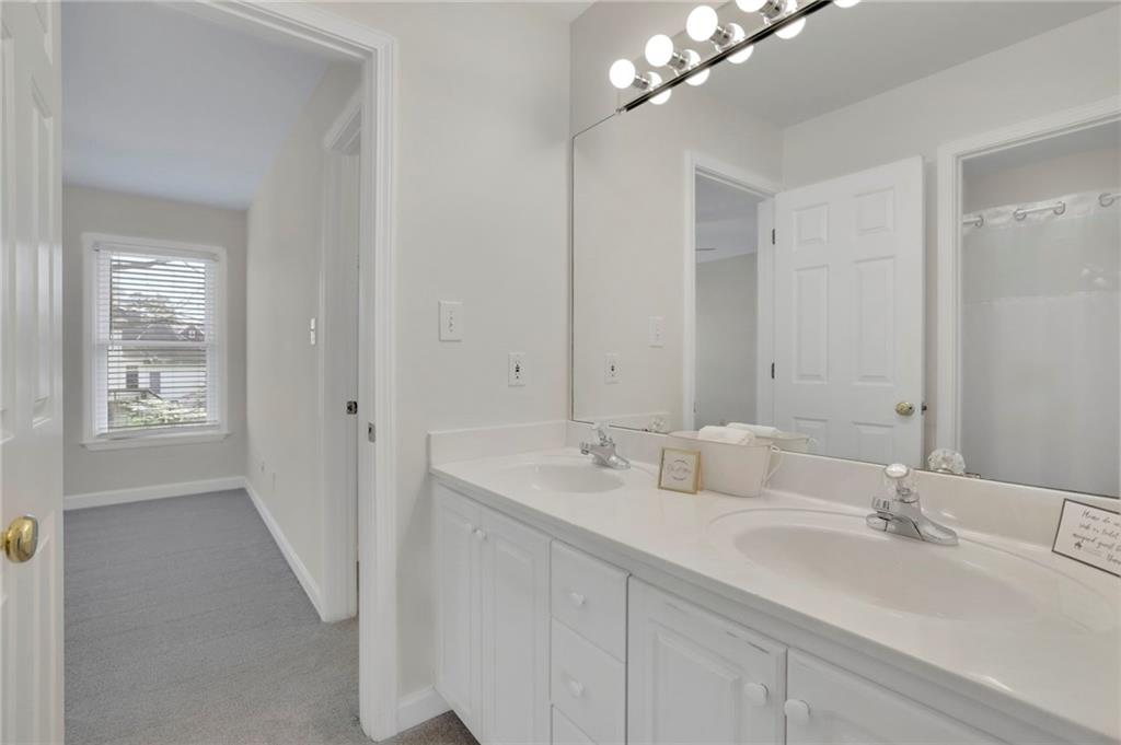 2430 Stonevalley Lane Cumming, GA 30041 - Photo 29 of 45 a bathroom with double sink and a mirror