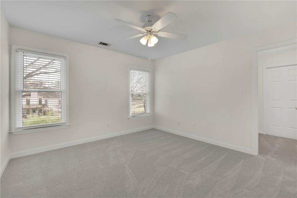 2430 Stonevalley Lane Cumming, GA 30041 - Photo 30 of 45 an empty room with a window and a ceiling fan