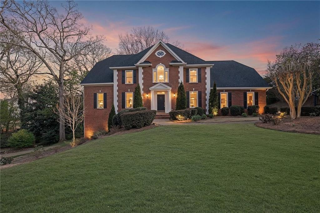 2430 Stonevalley Lane Cumming, GA 30041 - Photo 3 of 45 a front view of a house with a yard