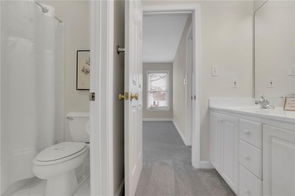 2430 Stonevalley Lane Cumming, GA 30041 - Photo 31 of 45 a bathroom with a sink a toilet and shower