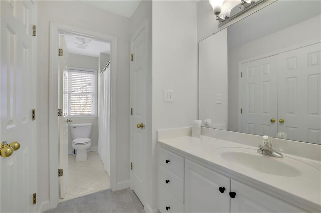 2430 Stonevalley Lane Cumming, GA 30041 - Photo 33 of 45 a bathroom with a double vanity sink and mirror
