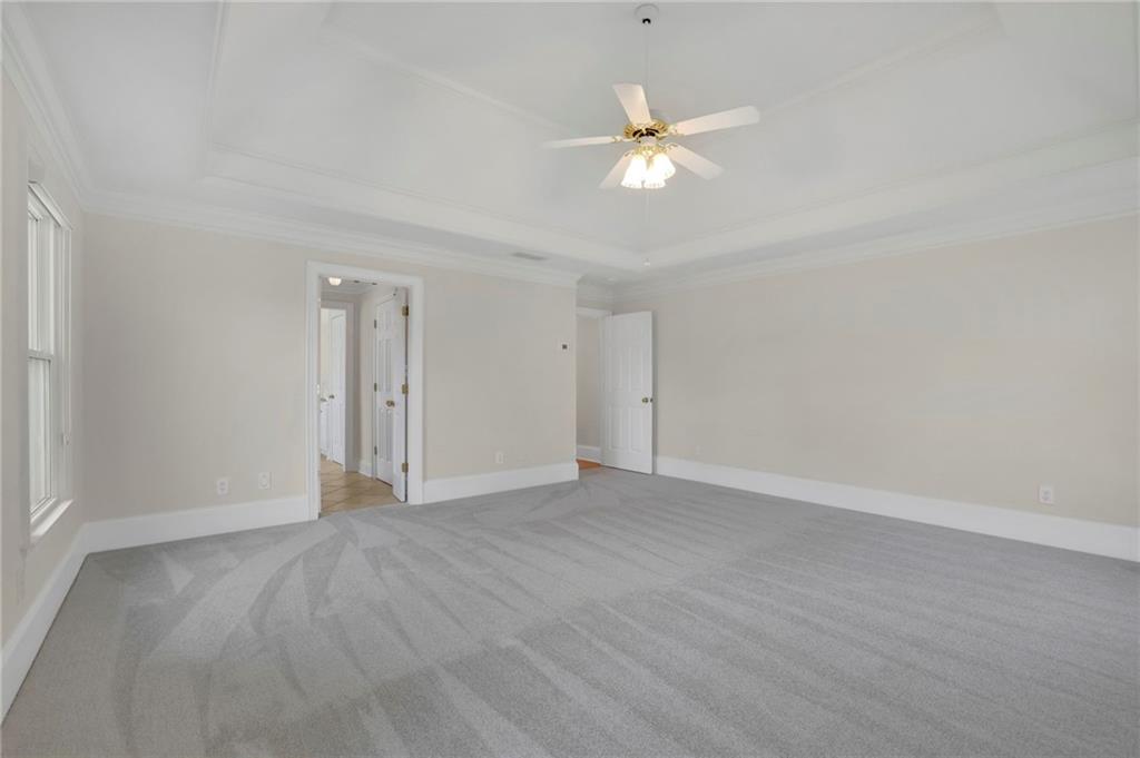 2430 Stonevalley Lane Cumming, GA 30041 - Photo 35 of 45 a view of an empty room with a chandelier fan