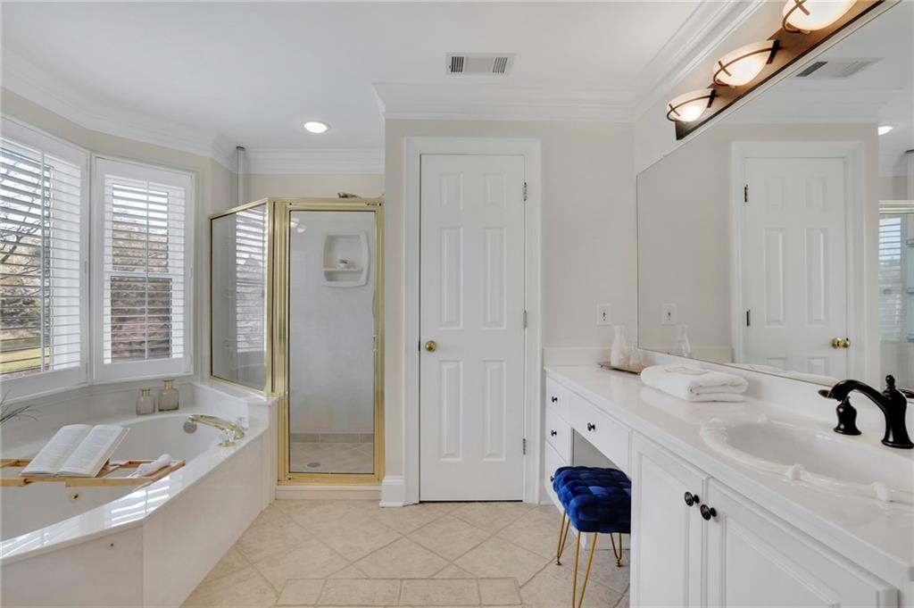 2430 Stonevalley Lane Cumming, GA 30041 - Photo 36 of 45 a bathroom with a tub sink and mirror
