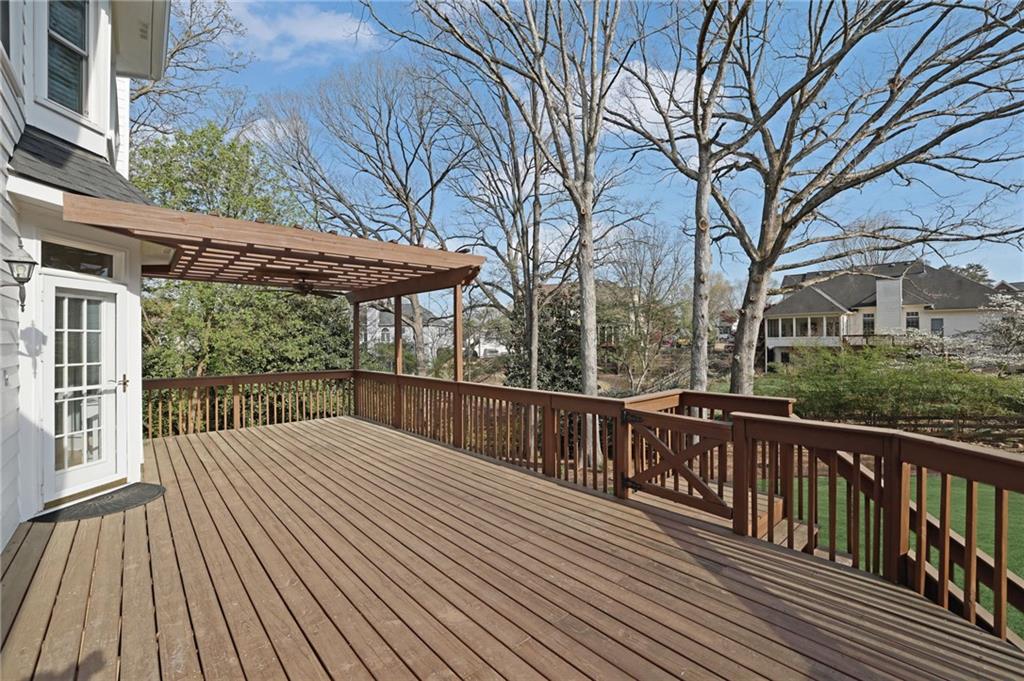 2430 Stonevalley Lane Cumming, GA 30041 - Photo 40 of 45 a view of backyard with a deck and wooden floor