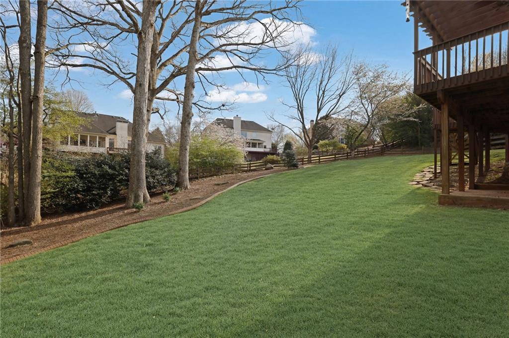 2430 Stonevalley Lane Cumming, GA 30041 - Photo 42 of 45 a view of a garden with a bench