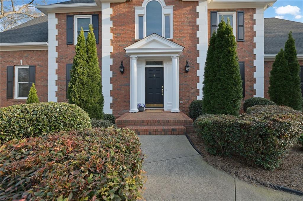2430 Stonevalley Lane Cumming, GA 30041 - Photo 8 of 45 front view of a house with a yard