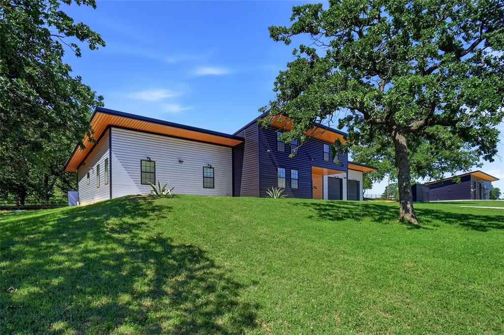 13240 Briar Road Azle, TX 76020 - Photo 2 of 39 a view of a house with a big yard potted plants and large tree