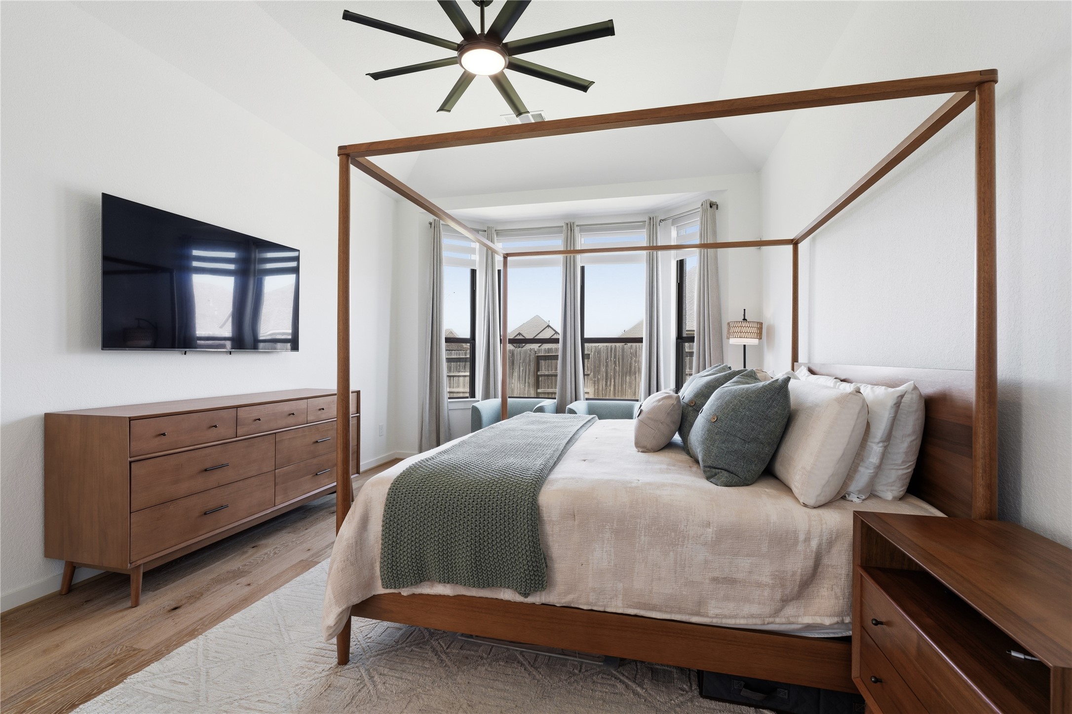 416 Bartlett Street Webster, TX 77598 - Photo 22 of 49 Primary bedroom with wall-mounted TV, dresser, and large windows