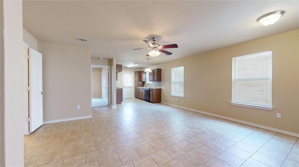 812 Parkplace Ridge Princeton, TX 75407 - Photo 3 of 13 Unfurnished living room with ceiling fan and baseboards