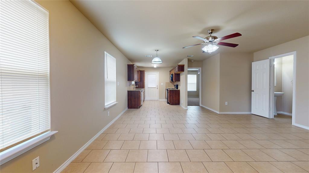 812 Parkplace Ridge Princeton, TX 75407 - Photo 3 of 17 Unfurnished living room featuring a ceiling fan and light tile patterned floors