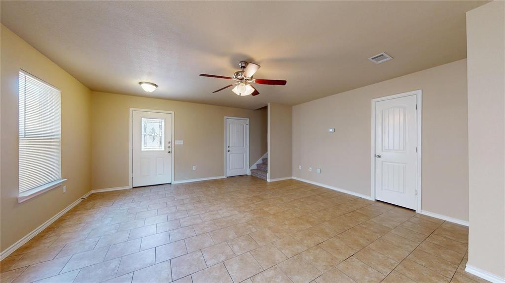 812 Parkplace Ridge Princeton, TX 75407 - Photo 5 of 13 Spare room featuring a ceiling fan, stairway, and light tile patterned flooring