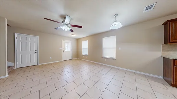 a view of an empty room and window fan