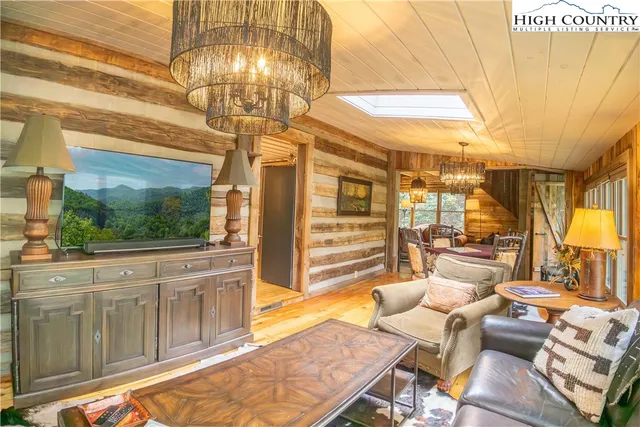 a view of a patio with a table chairs and wooden floor