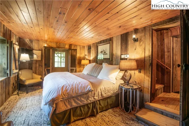 a bed room with a bed and a large window