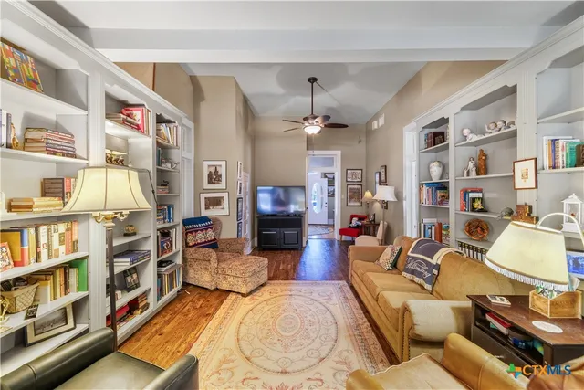 a living room with furniture and a book shelf