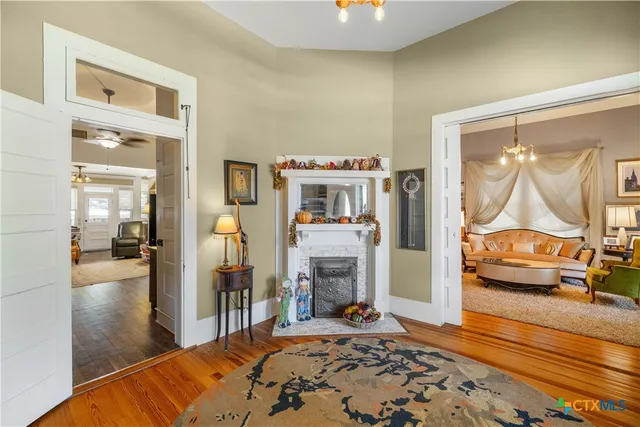 a bedroom with furniture and a wooden floor