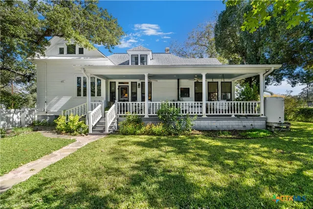 a view of a house with a yard and deck
