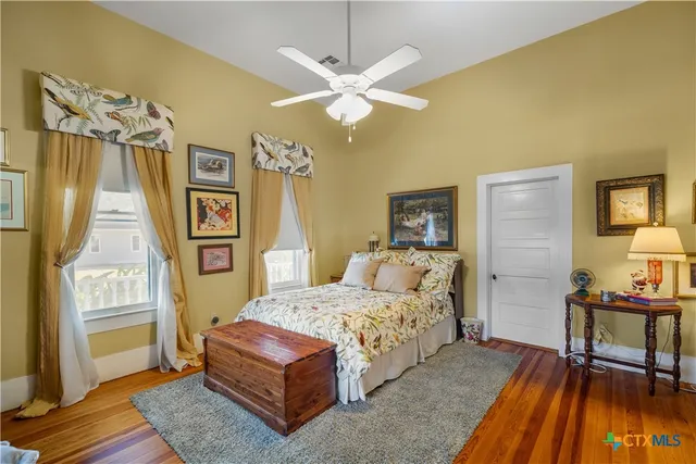 a bedroom with a bed dresser and a window