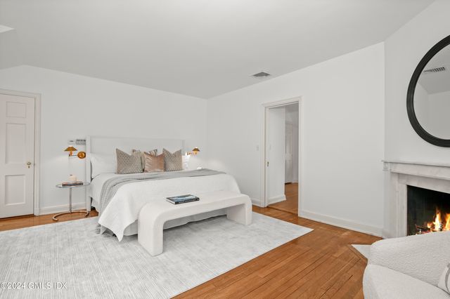 a bedroom with a bed and a fireplace