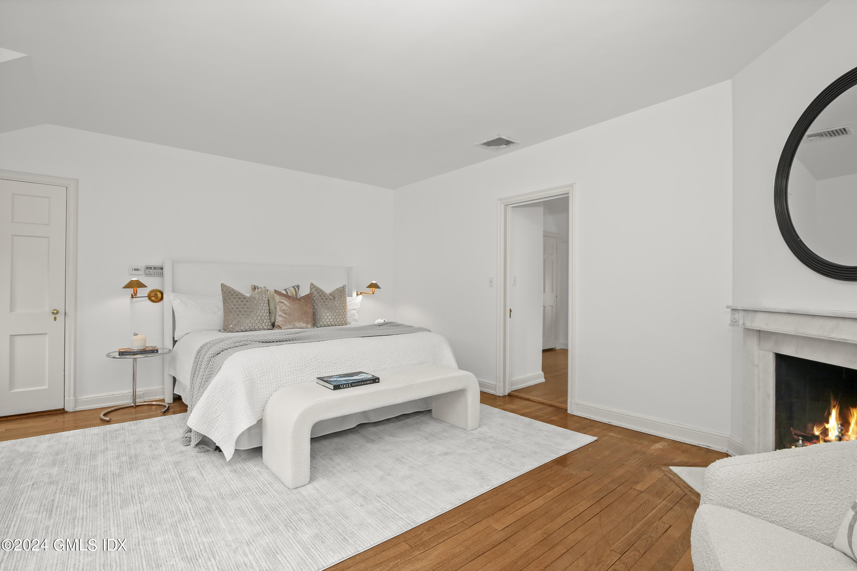 528 Field Point Road Greenwich, CT 06830 - Photo 14 of 31 a bedroom with a bed and a fireplace