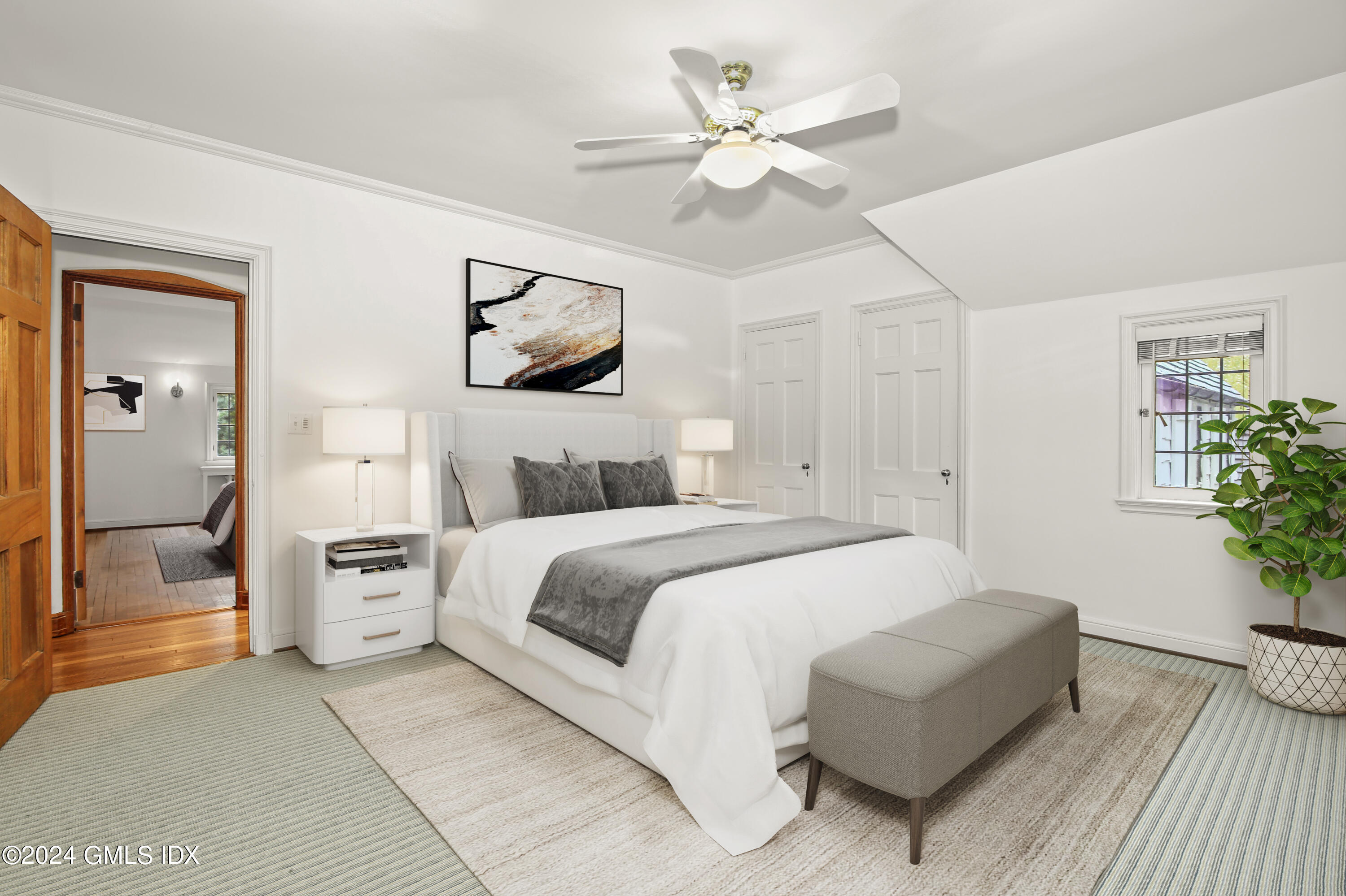 528 Field Point Road Greenwich, CT 06830 - Photo 17 of 31 a bedroom with a large bed and a chandelier