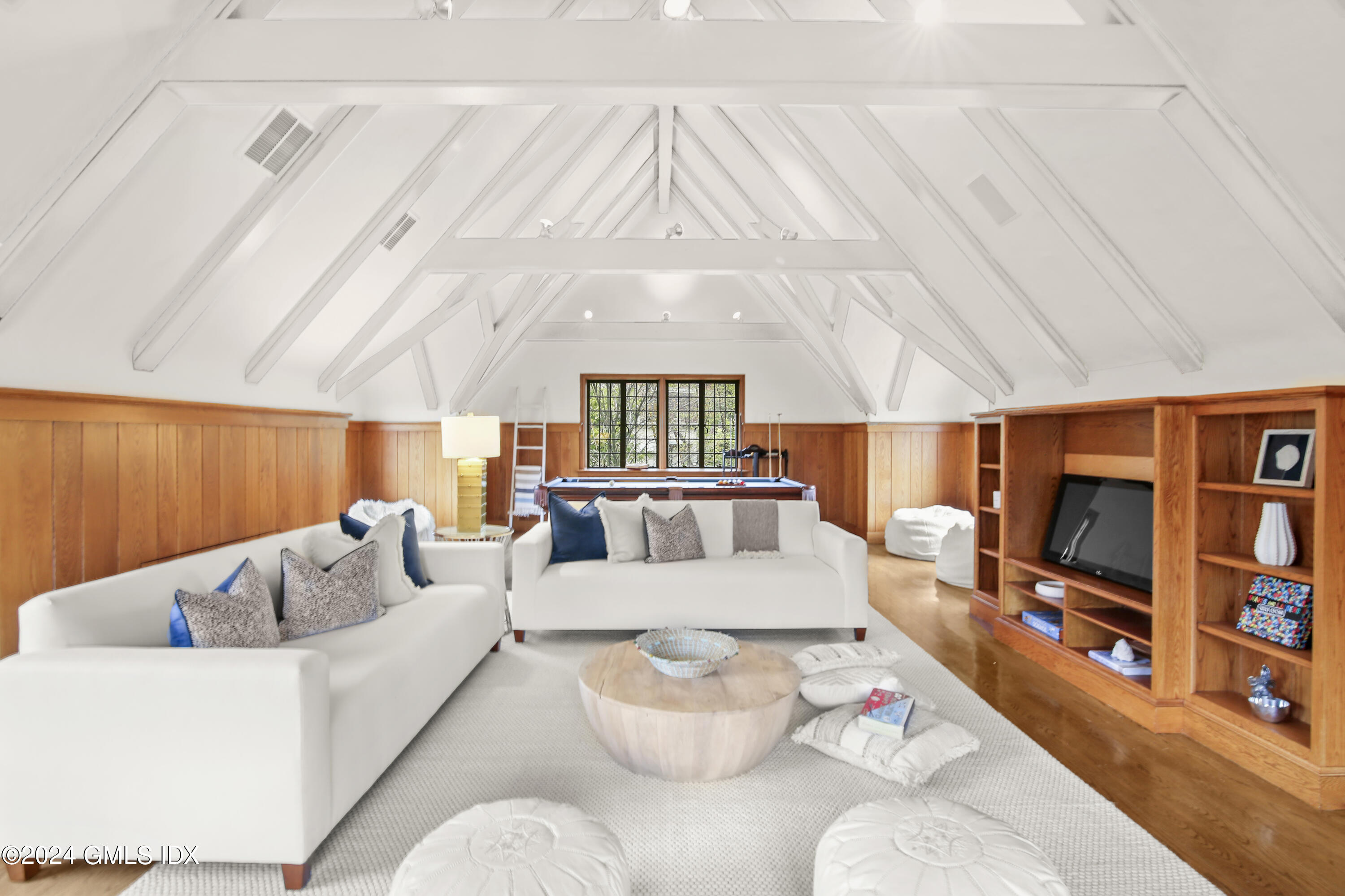 528 Field Point Road Greenwich, CT 06830 - Photo 20 of 31 a living room with furniture a rug and a flat screen tv