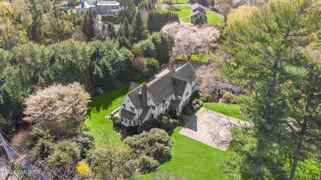 an aerial view of a house with a yard and a fountain