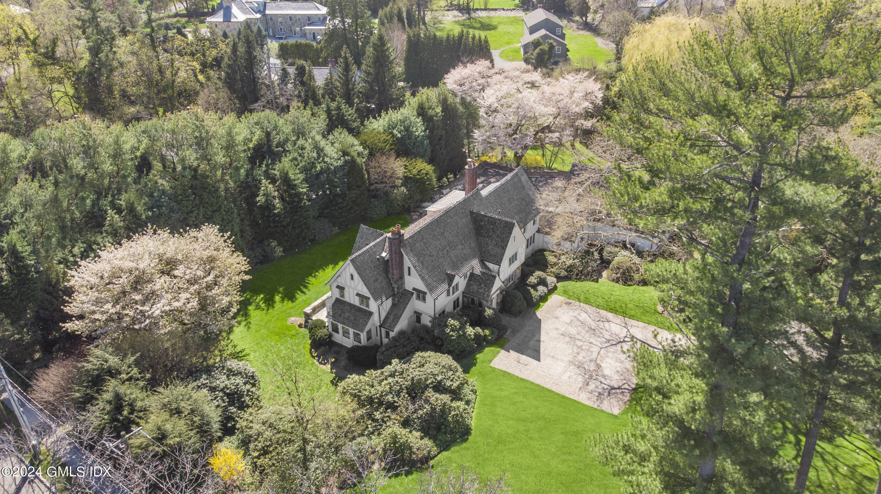 528 Field Point Road Greenwich, CT 06830 - Photo 2 of 31 an aerial view of a house with a yard and a fountain