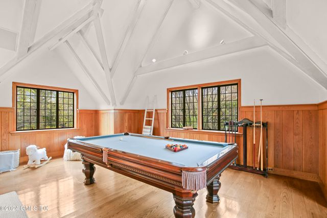 a room with pool table and windows