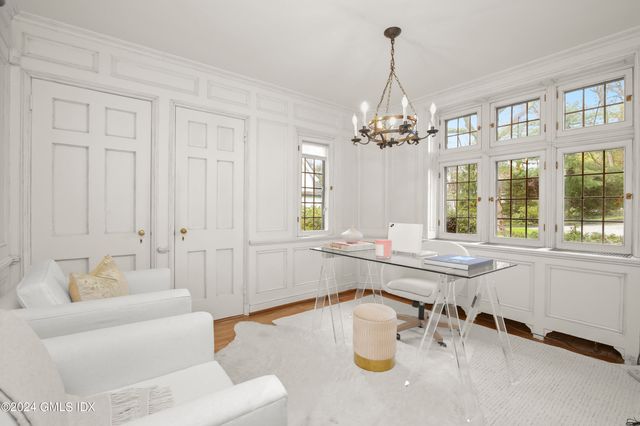 a large white kitchen with a large window
