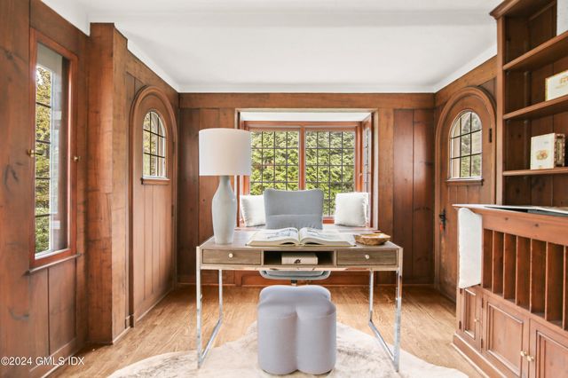 a room with furniture a window and a potted plant