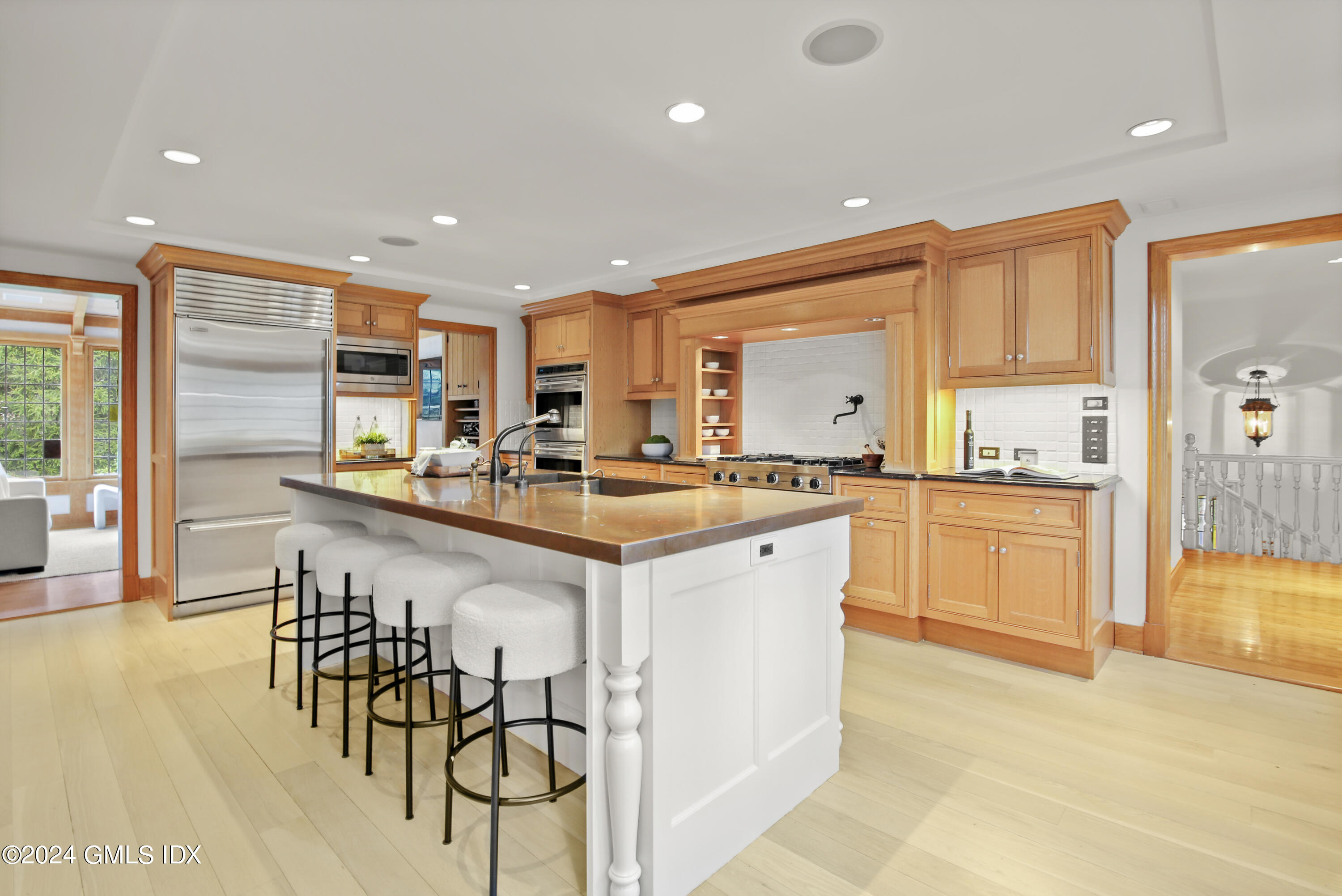 528 Field Point Road Greenwich, CT 06830 - Photo 10 of 31 a kitchen with stainless steel appliances kitchen island granite countertop a stove a sink and a refrigerator