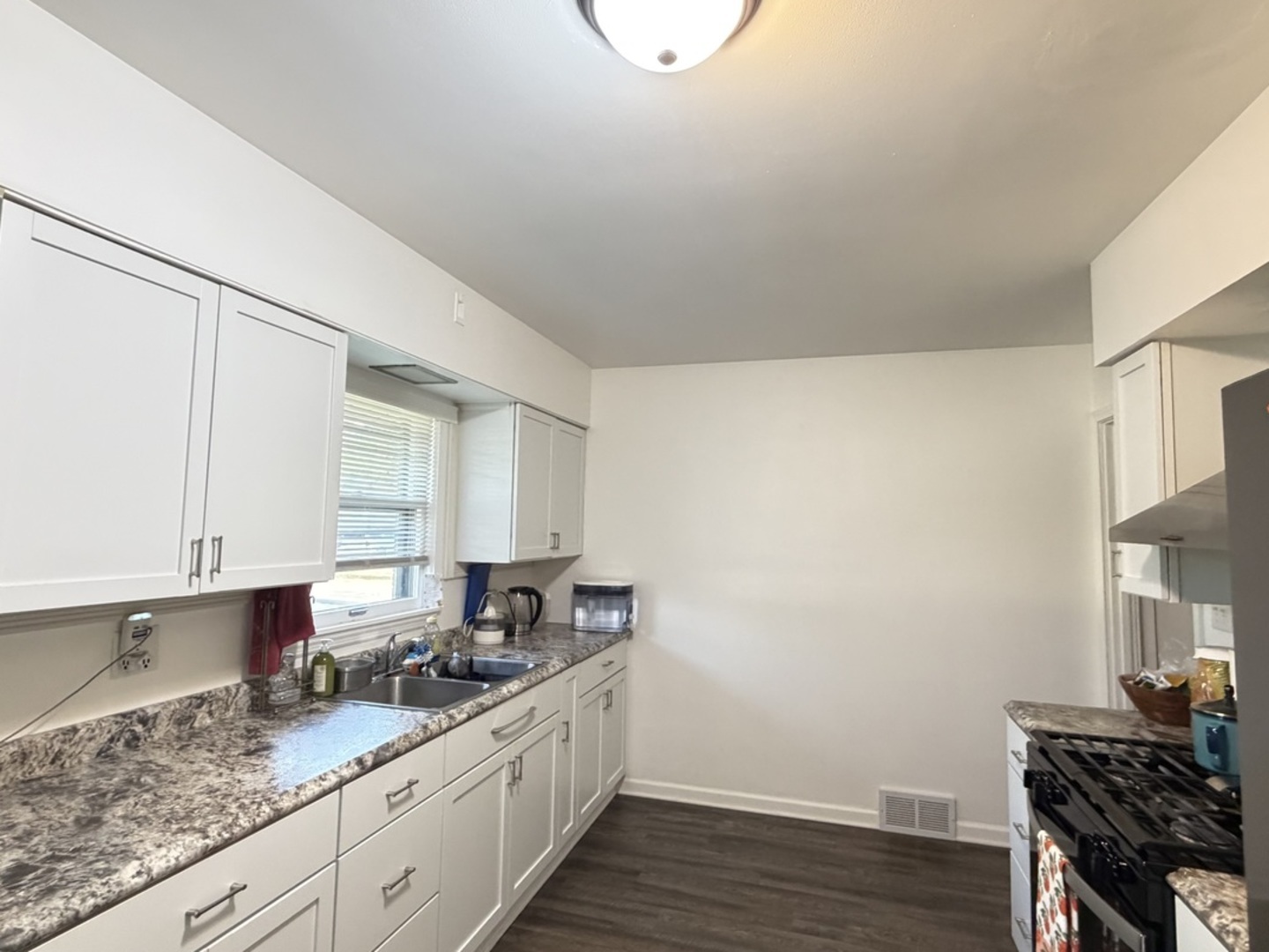 900 Westminster Road Joliet, IL 60435 - Photo 7 of 16 a kitchen with granite countertop a sink cabinets and wooden floor