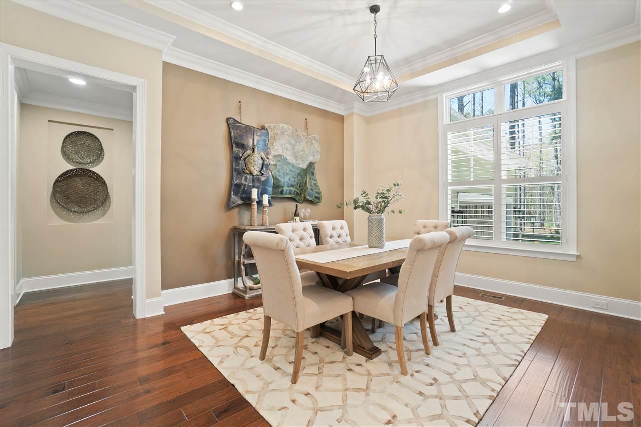1504 Brassfield Road Raleigh, NC 27614 - Photo 11 of 30 a dining room with wooden floor and chandelier