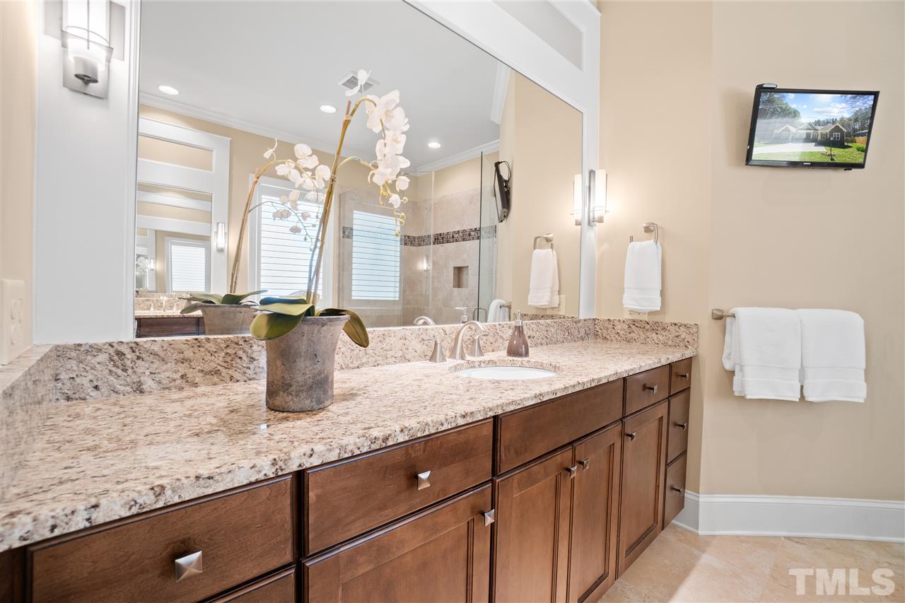 1504 Brassfield Road Raleigh, NC 27614 - Photo 17 of 30 a bathroom with a granite countertop sink and a mirror