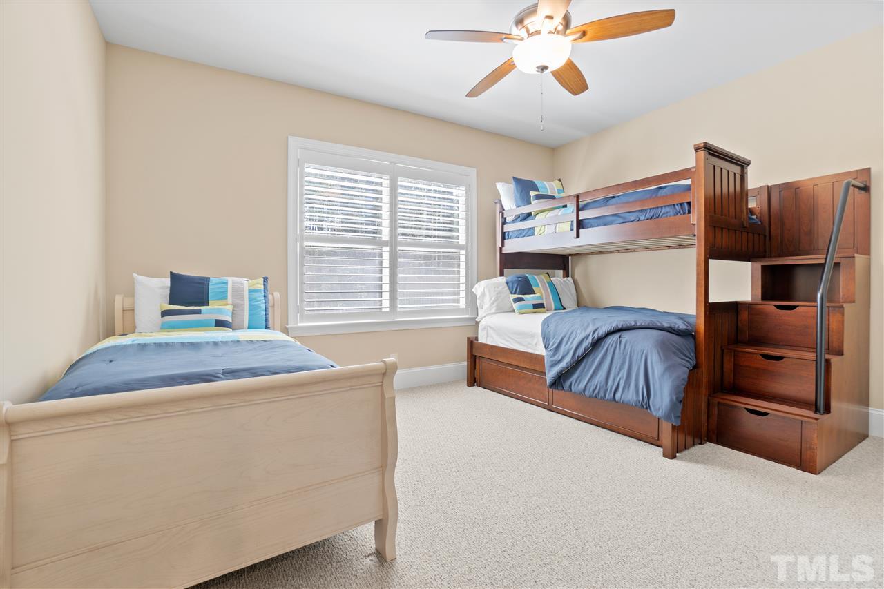 1504 Brassfield Road Raleigh, NC 27614 - Photo 18 of 30 a bedroom with a bed and a chandelier