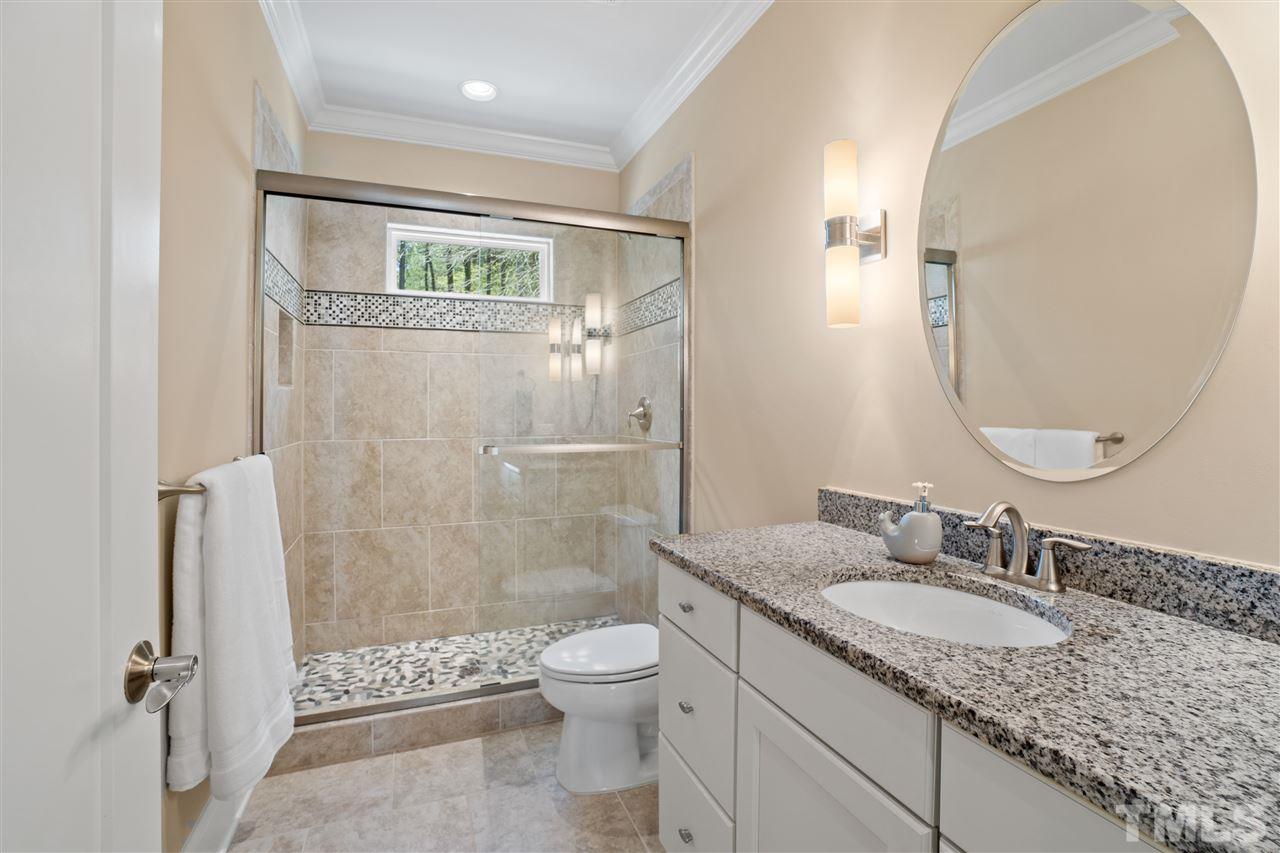 1504 Brassfield Road Raleigh, NC 27614 - Photo 19 of 30 a bathroom with a granite countertop sink toilet and shower