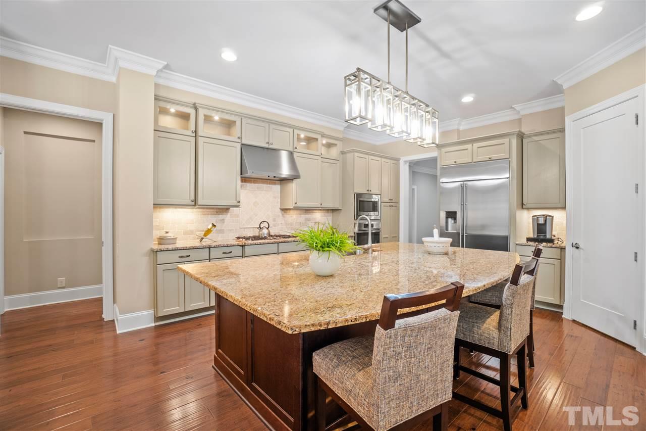 1504 Brassfield Road Raleigh, NC 27614 - Photo 3 of 30 a view of a dining room and livingroom with furniture wooden floor a chandelier