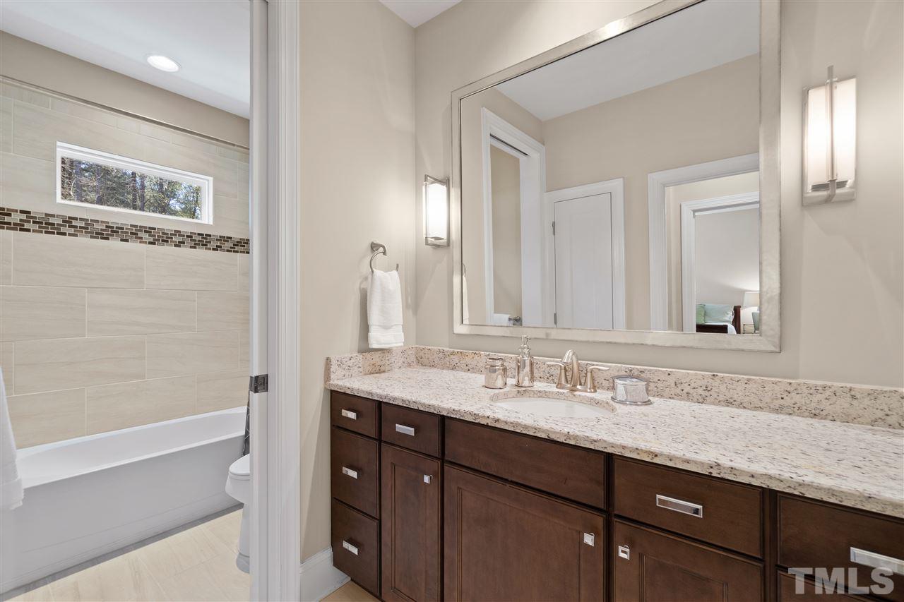1504 Brassfield Road Raleigh, NC 27614 - Photo 21 of 30 a bathroom with a granite countertop double vanity sink and mirror