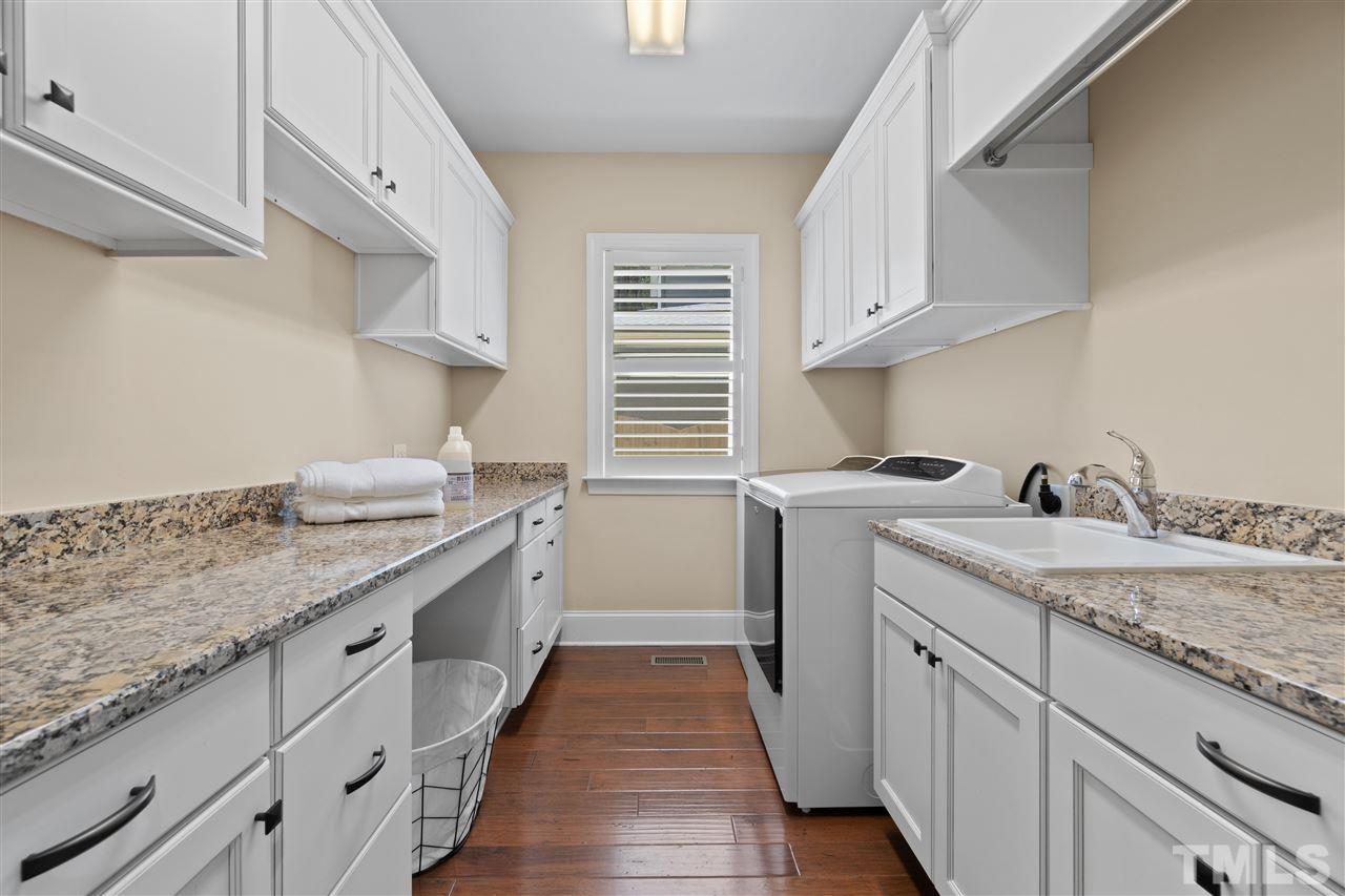 1504 Brassfield Road Raleigh, NC 27614 - Photo 25 of 30 a kitchen with a sink stove and cabinets