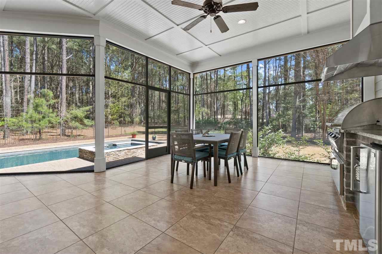 1504 Brassfield Road Raleigh, NC 27614 - Photo 26 of 30 a dining room with furniture and a floor to ceiling window